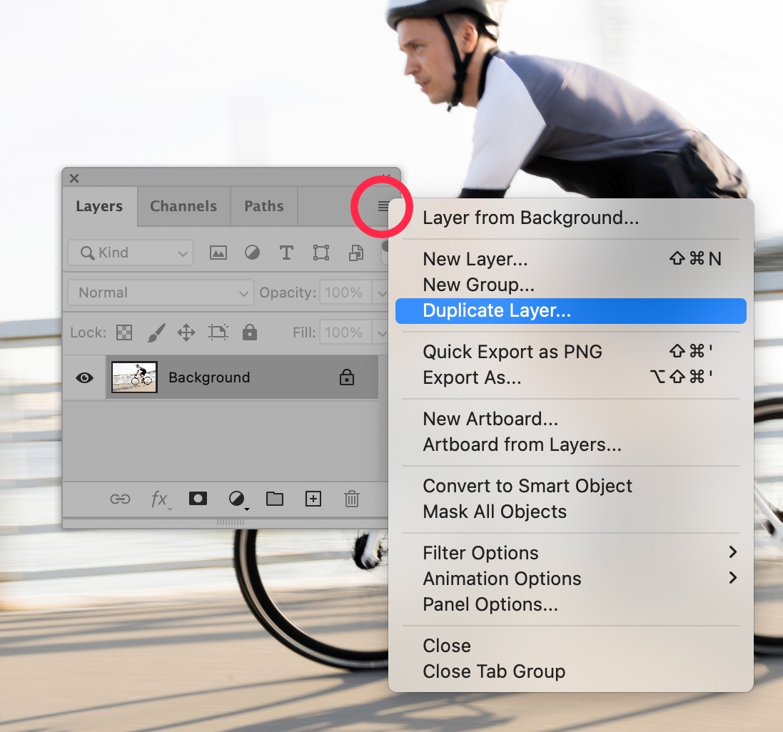 Photoshop Layers panel with Duplicate Layer option selected, preparing a new layer for non-destructive image editing on a cycling photo.