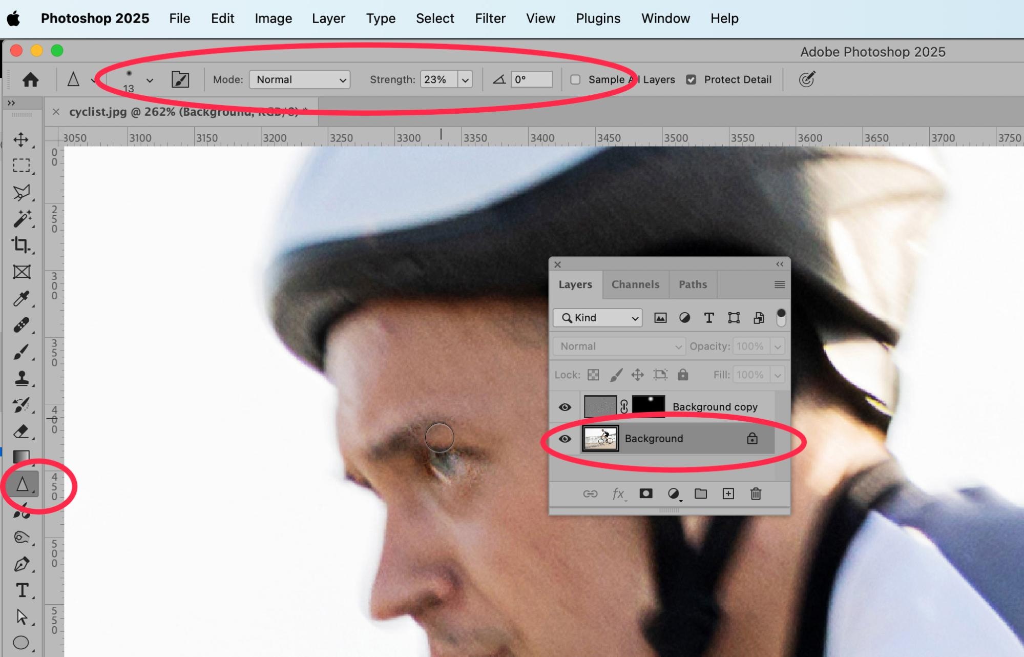 Photoshop 2025 interface showing the Sharpen Tool in use on a cyclist’s face, with the background layer selected and tool settings highlighted for precision image enhancement.