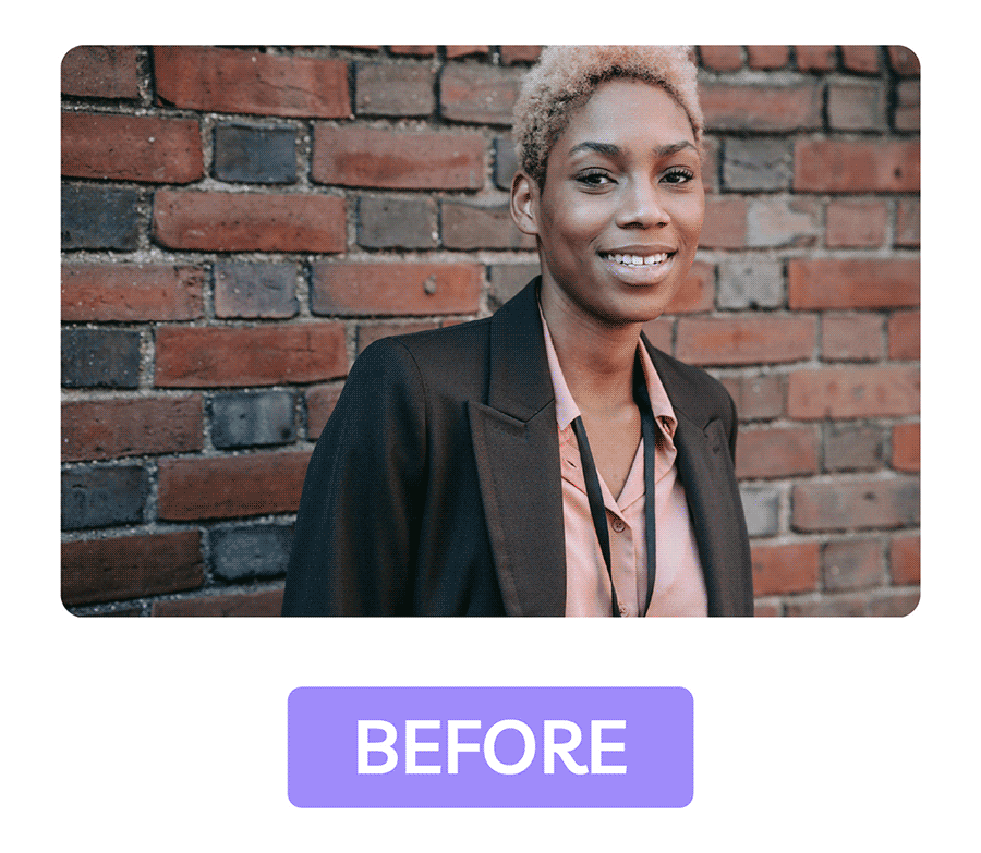 Unedited headshot of woman in blazer against brick wall, showing minimal background blur with natural texture.