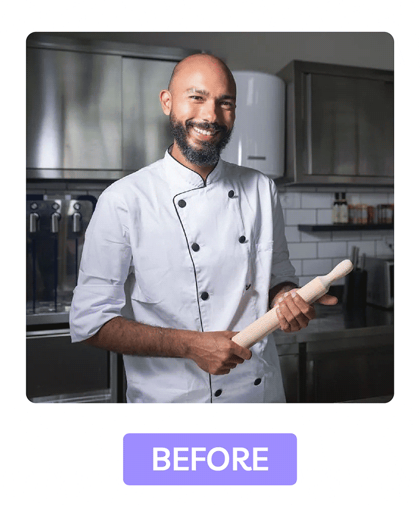 Headshot of chef in uniform holding rolling pin, showing natural clothing wrinkles in unedited image.