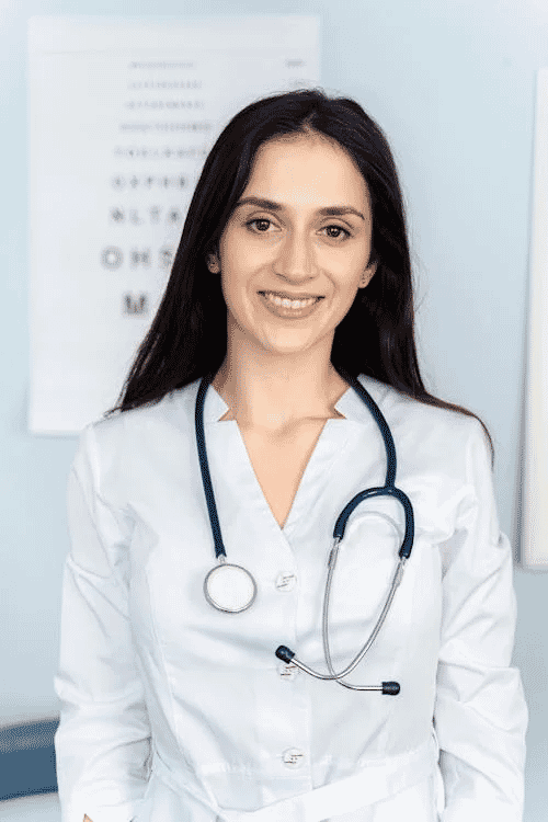 Headshot of a female doctor in a white coat with stethoscope, exemplifying effective use of minimal props.