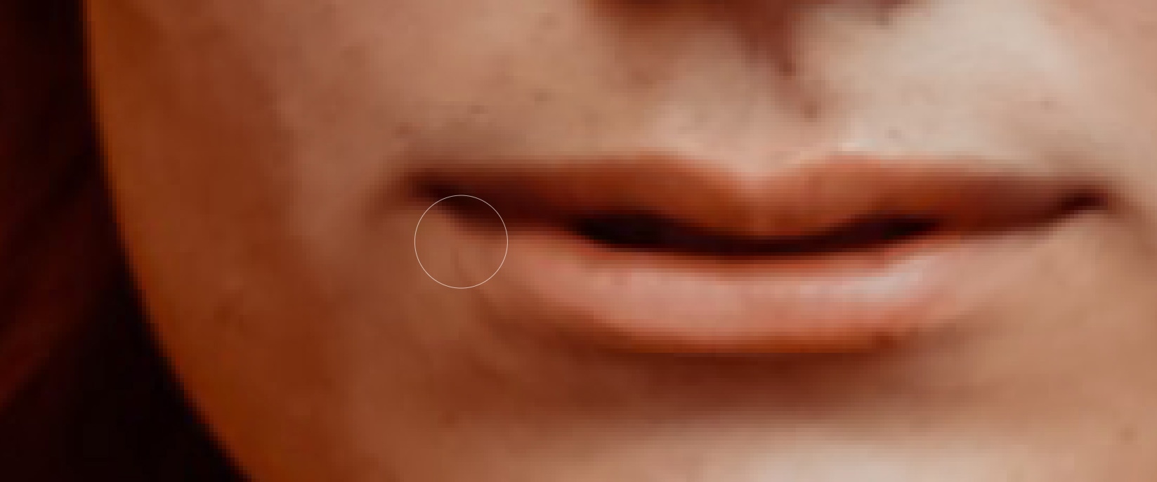 Close-up view of smile adjustment in Photoshop Liquify tool for a natural enhancement effect.