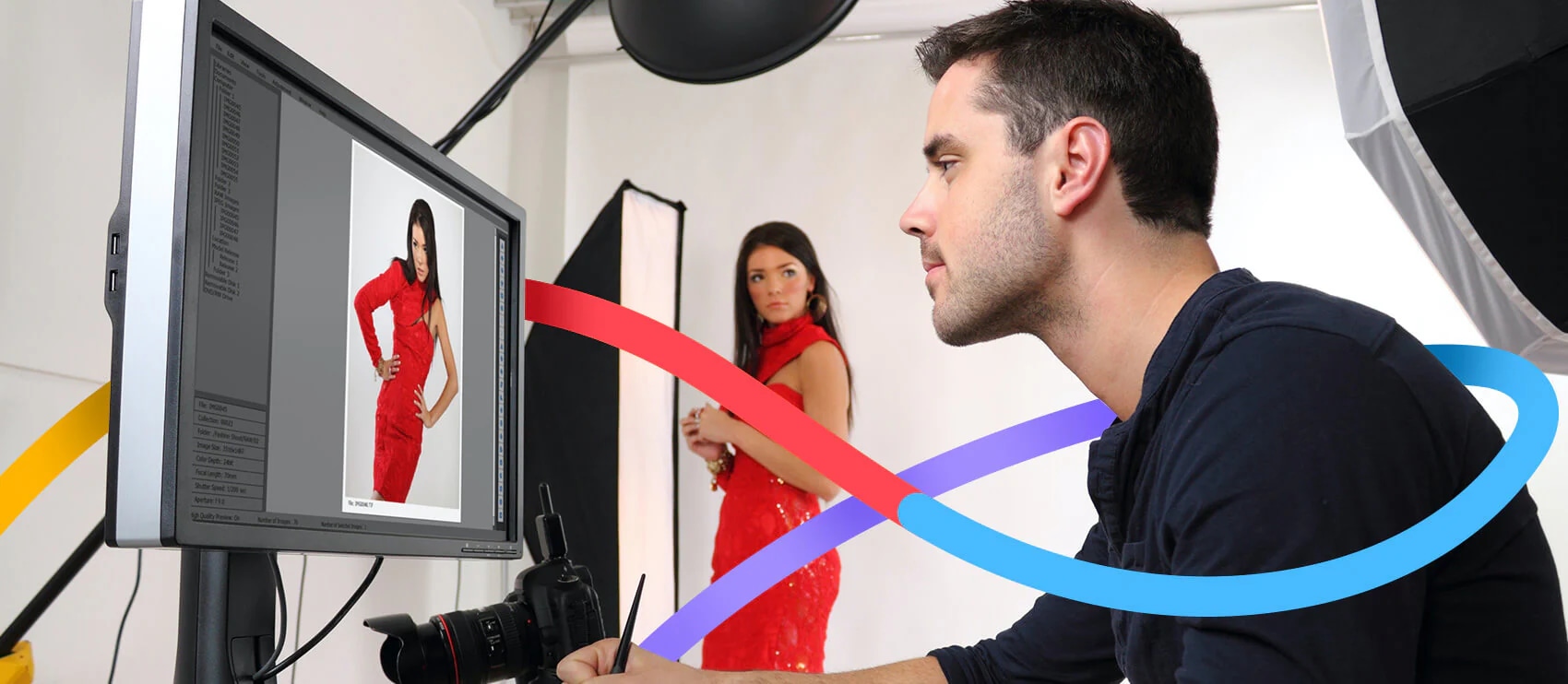 Photographer editing a model's image on screen during a fashion shoot in a studio