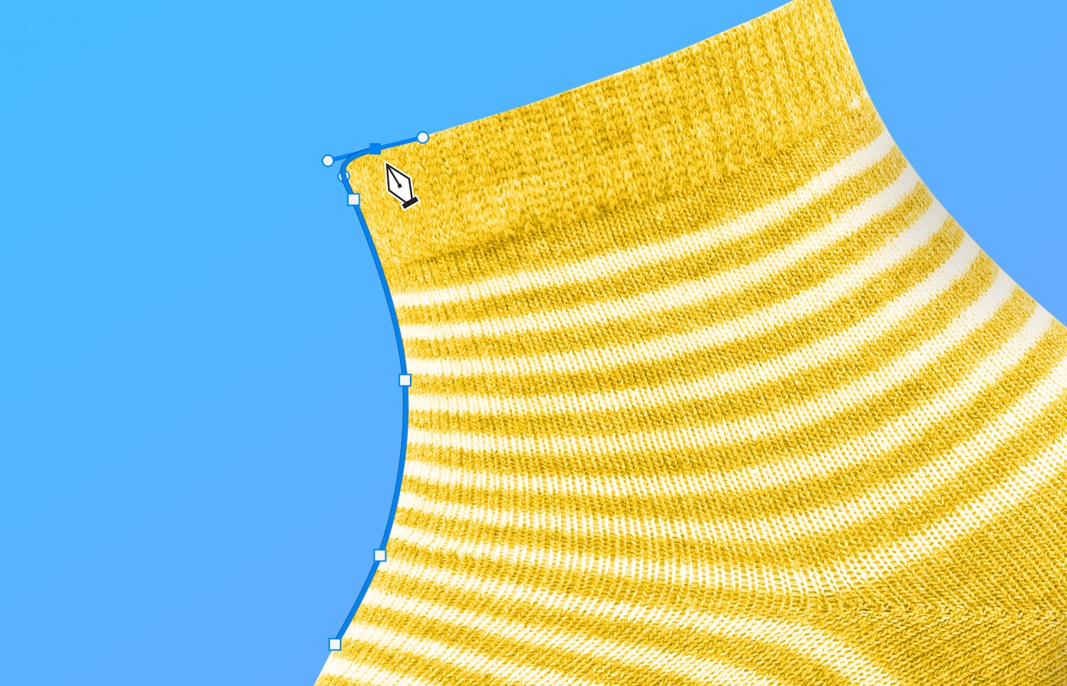Photoshop Pen Tool creating a path along the edge of a yellow striped sock on a blue background.