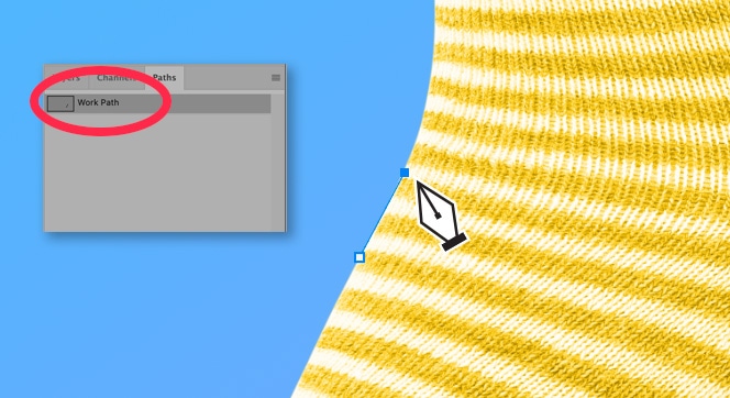 Photoshop interface showing the Pen Tool creating a work path along the edge of a yellow striped sock on a blue background.