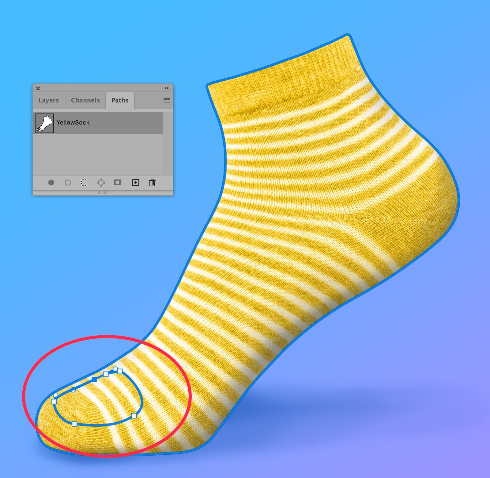 Yellow striped sock in Photoshop with a saved path outline around the sock and an additional path circled around the toe area. Paths panel shows "YellowSock" path saved.