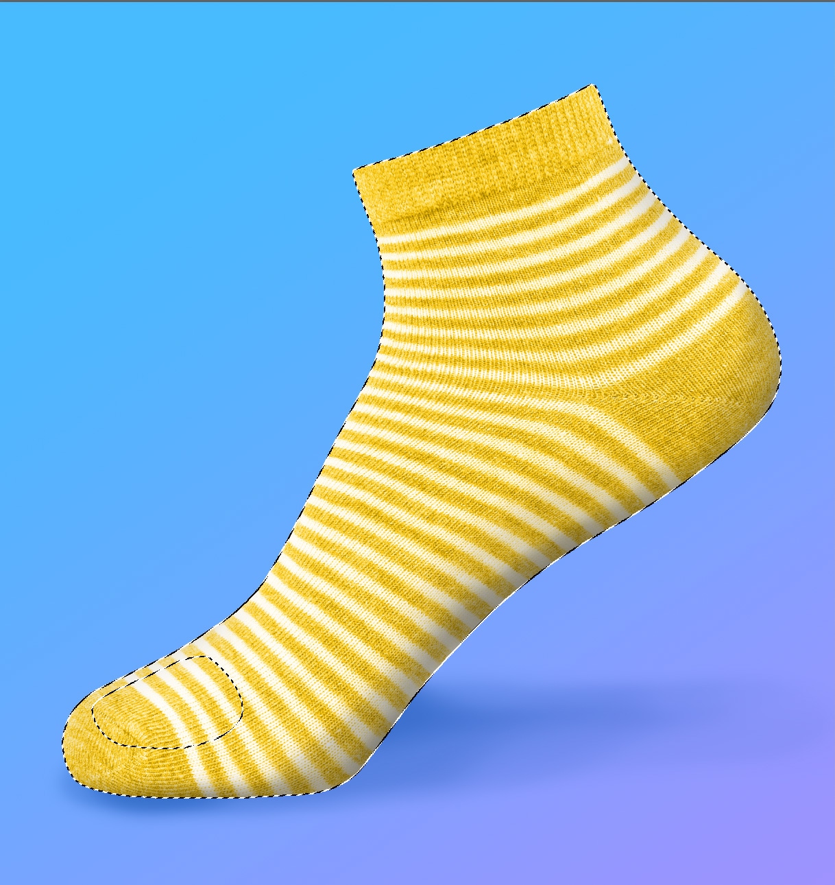 Yellow striped sock on a blue gradient background with a path selection outline visible in Photoshop.