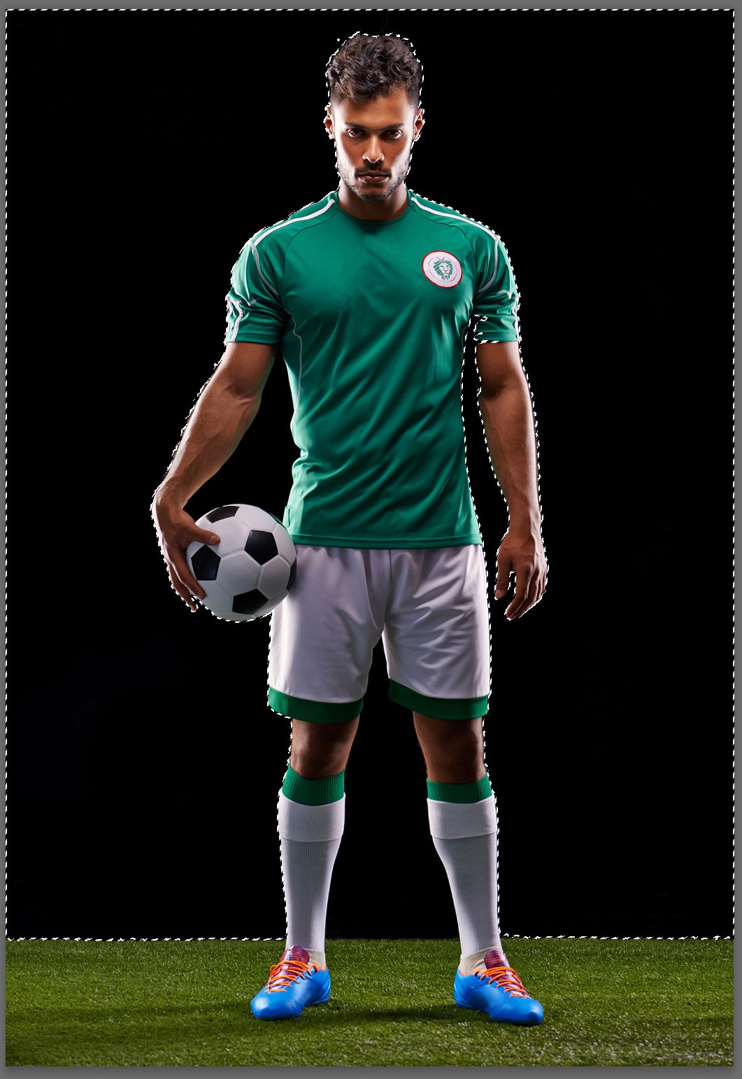 soccer player standing on grass with black background and checked lines around the black background border
