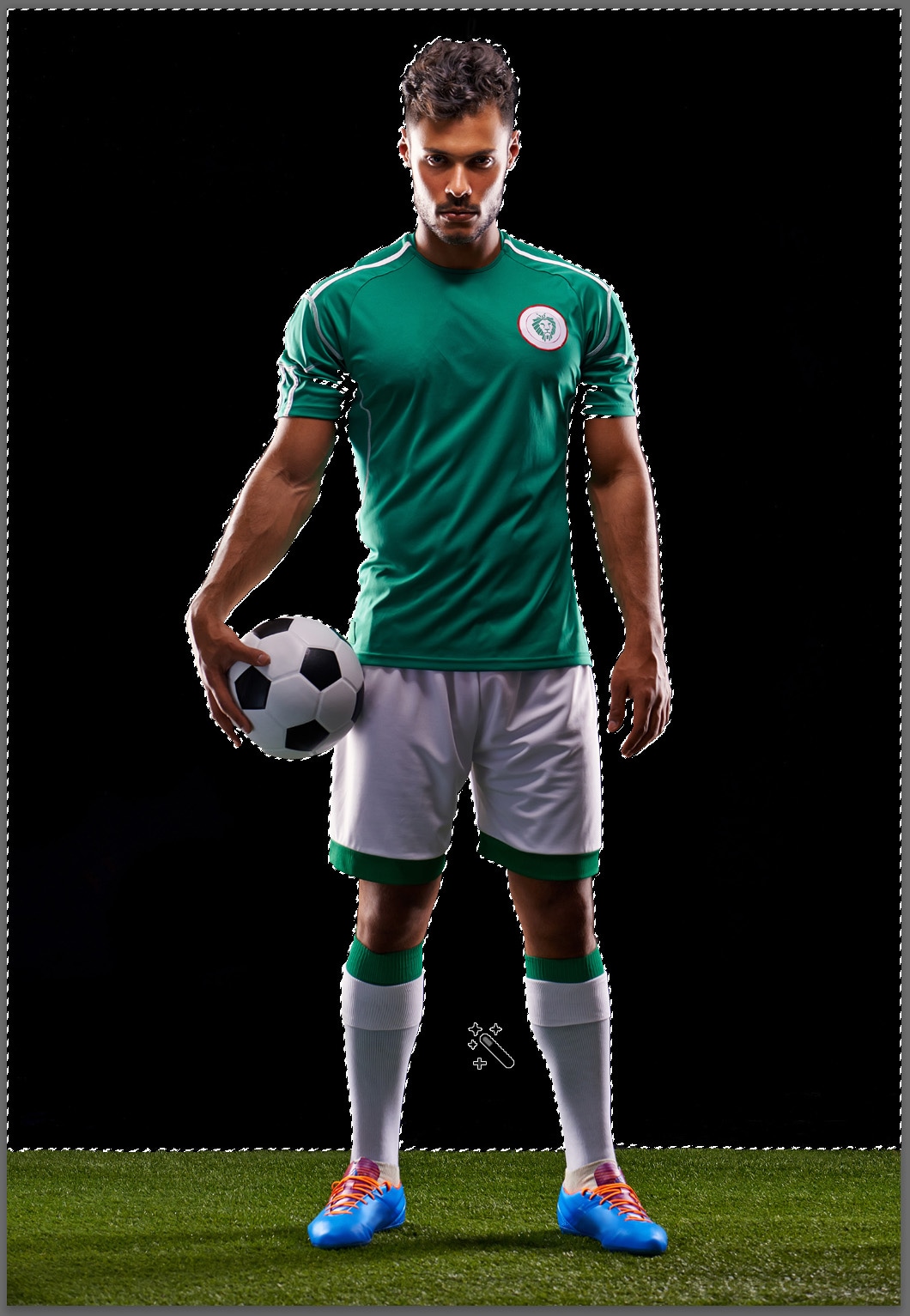 soccer player with black background standing on grass and the borders of the athlete and the background are outlined