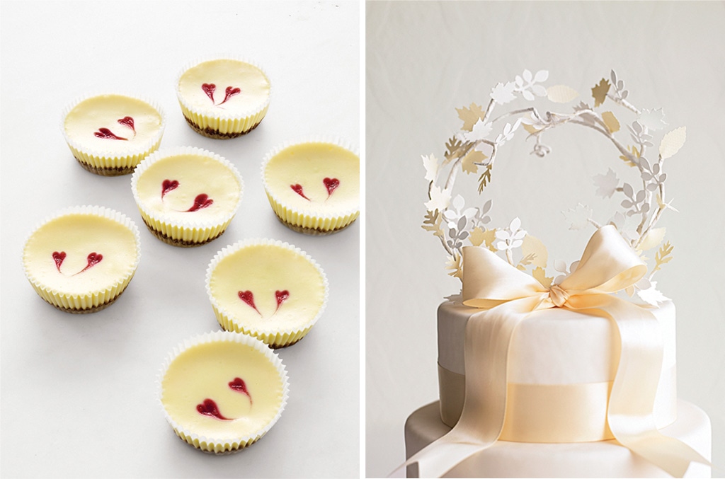 Mini cheesecakes with heart decorations next to a wedding cake adorned with a floral paper topper and ribbon.