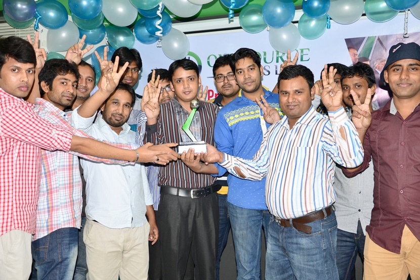 Outsource Experts Ltd. team posing and celebrating BASIS Outsourcing Award with thumbs-up
