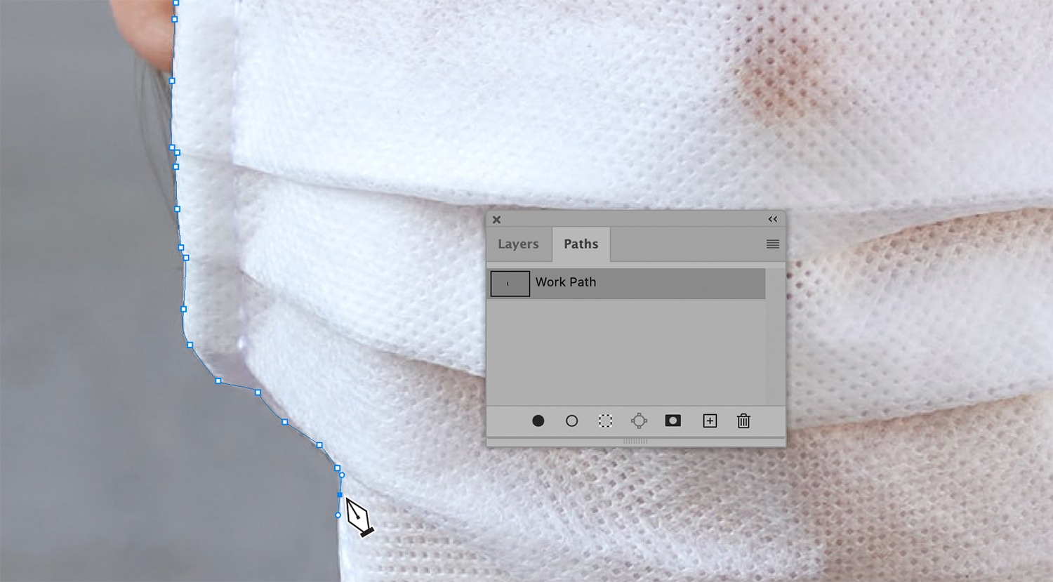 Close-up of Photoshop’s Pen Tool outlining a work path on a textured white surface with the Paths panel displayed.