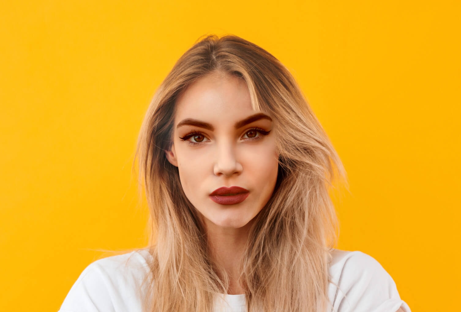 Completed face swap with seamlessly blended facial features on a yellow background