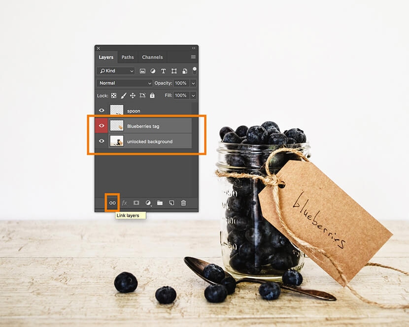 Photoshop Layers panel showing "Blueberries tag" and "unlocked background" layers linked for synchronized editing