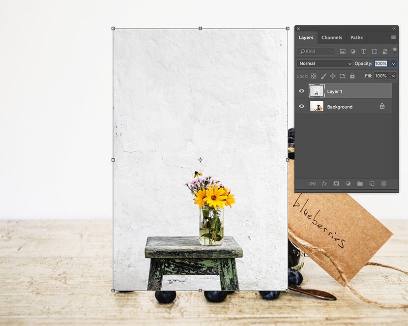 Photoshop showing transformation controls on a layer with a flower vase over the background