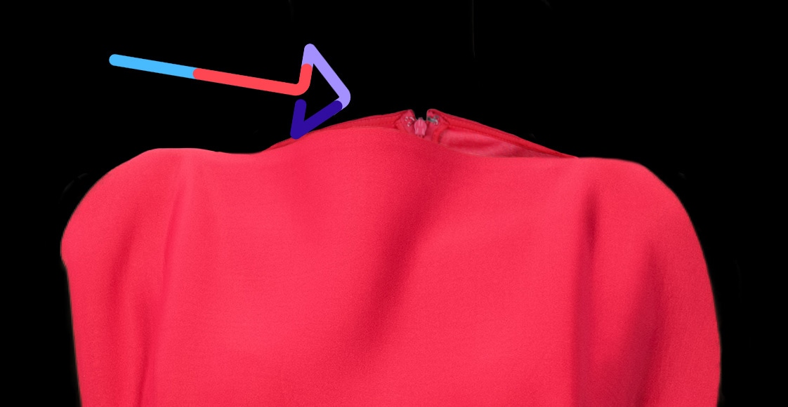 Red dress neckline with highlighted zipper detail, on a black background.
