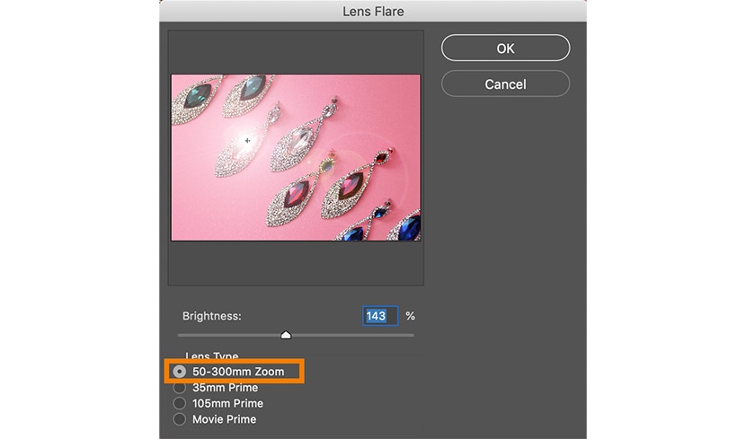 Photoshop lens flare settings for jewelry photo, with 50-300mm zoom lens type and brightness adjustment on a pink background.