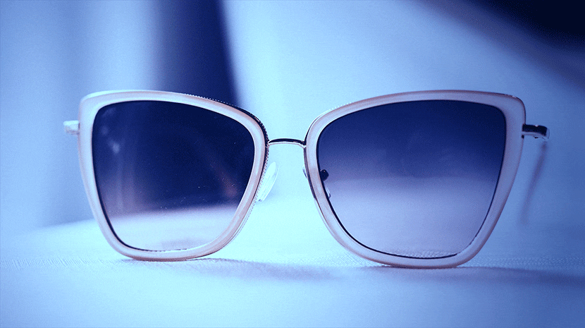 Photo of sunglasses with an intense blue vintage effect, highlighting bold color adjustments for a dramatic retro appearance.