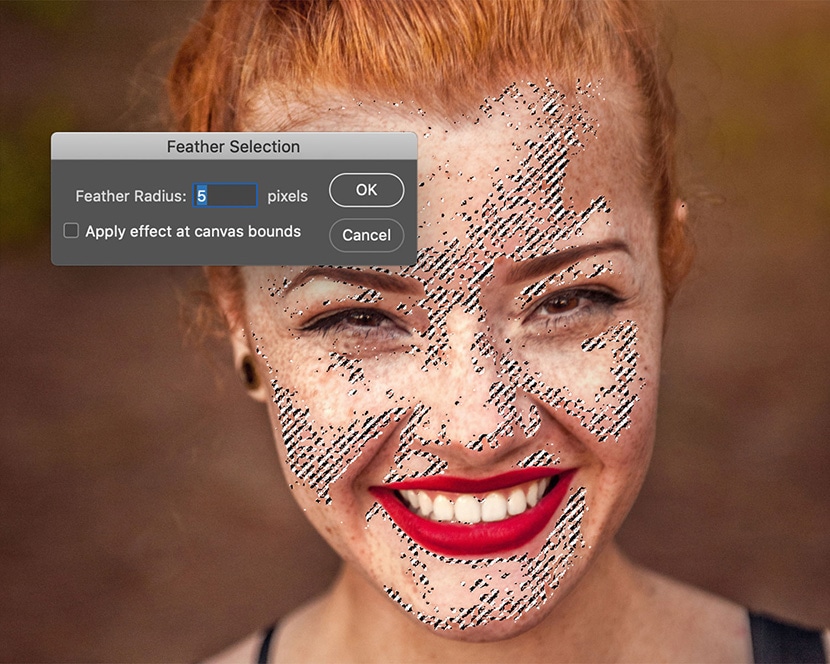 Applying Photoshop feather tool with 5-pixel radius for smooth skin selection in ecommerce photo editing.