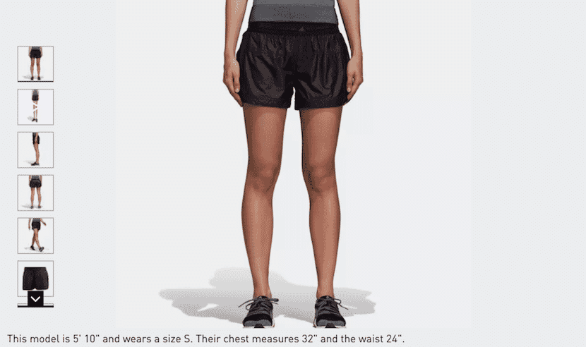 Model wearing black athletic shorts with size and measurements listed underneath.