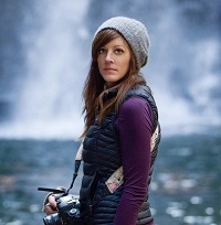 Professional headshot of a woman against a neutral background, highlighting a confident and approachable expression.