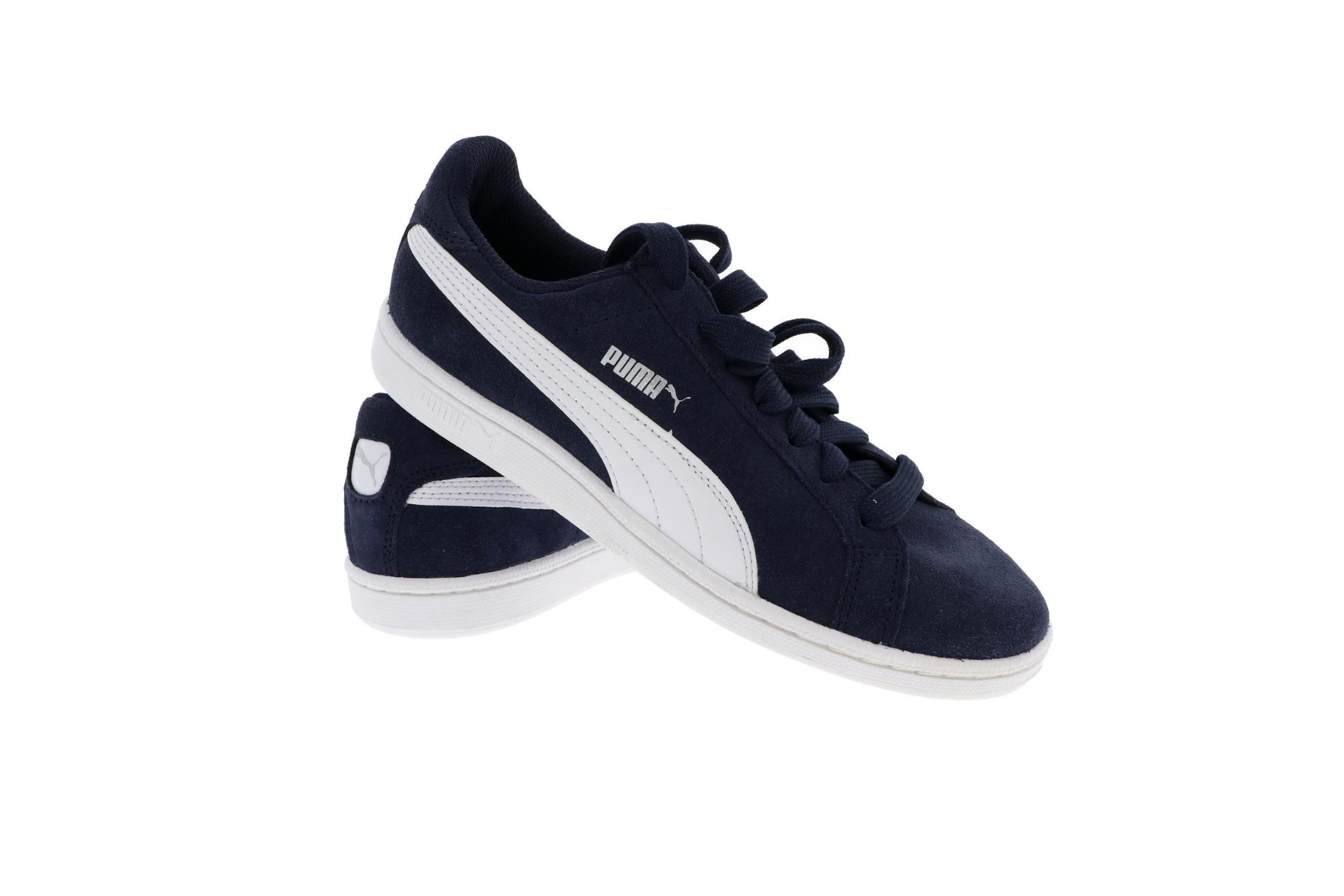 Navy and white Puma suede sneakers with side logo on a clean white background