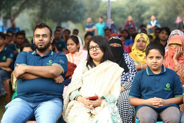 Path employees with family members seated at a team-building event, promoting a family-friendly atmosphere.