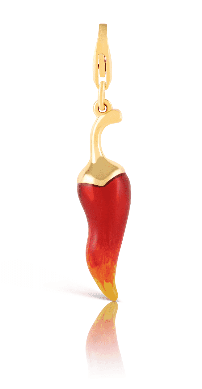 Gold and red pepper-shaped charm pendant with reflection shadow on white background