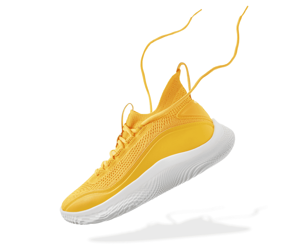 Bright yellow athletic shoe with laces floating and a soft shadow effect on a white background