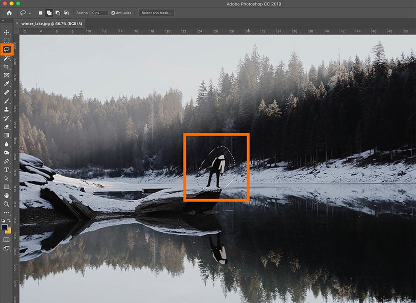 Removing a person from a winter lake scene in Photoshop using selection tools.