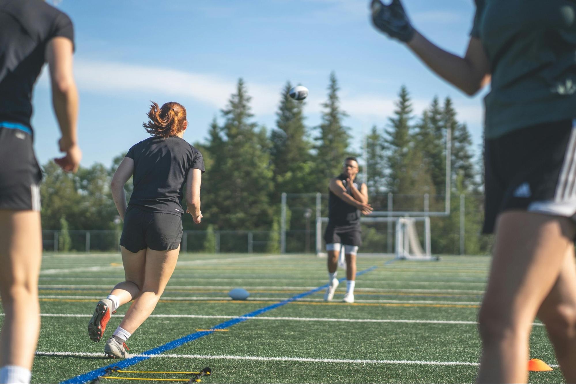 Athletes playing on a field during a sports practice session, showcasing action and movement